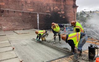 civil construction team pouring concrete on mezzanie