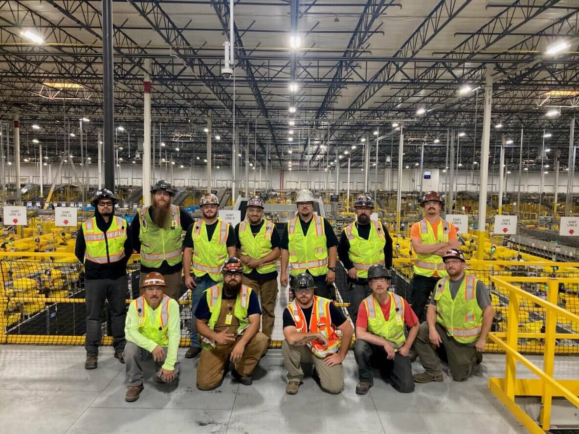 Millwright team installing conveyor in distribution center