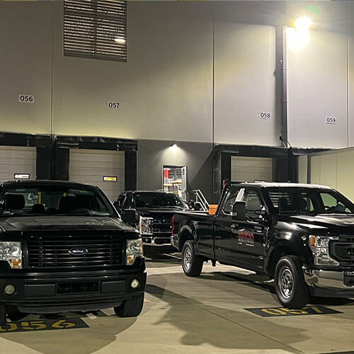 material handling installation team trucks parked a distribution center