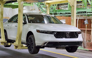 vehicle moves through auto manufacturing system